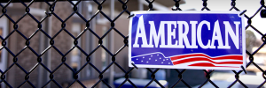 photo of American Fence sign on black chain link fence.