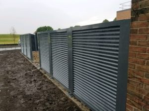 perspective view of gray metal horizontal louvered screening panels
