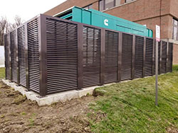 Grand Island fence company Nebraska commercial fence contractors architectural mechanical screening screen louvered semi private private solid staggered board on board shadow box alternating industrial louvers rooftop louvers chillers generators truck wells outside storage condensors rooftop equipment patios trash dumpsters transformers HVAC courtyards pool equipment fence aluminum galvanized steel degree of openness direct visibility standalone wall louvers