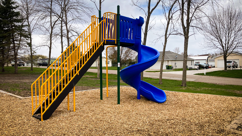 Blue slide with stairs and top platform. Playground company Grand Island, Nebraska playground installation playground equipment slides swings surfacing climbers children recreation safety durable