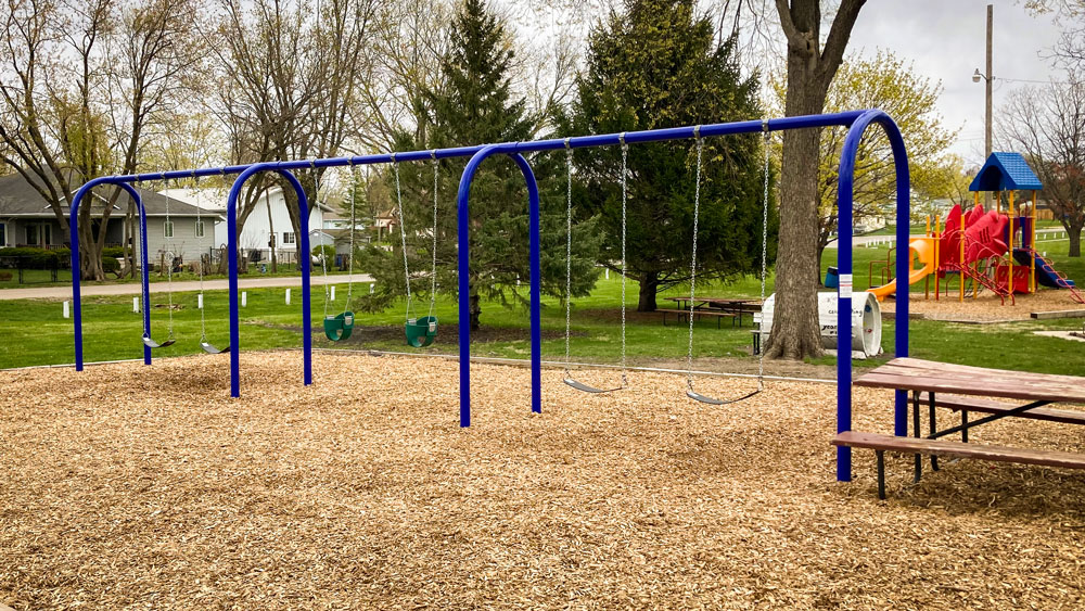 Swing set with blue metal frame for small residential park. Playground company Grand Island, Nebraska playground installation playground equipment slides swings surfacing climbers children recreation safety durable