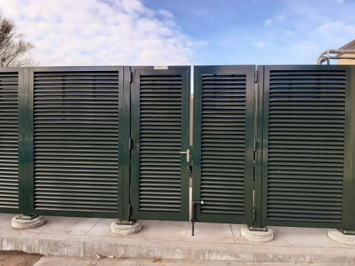 Grand Island fence company commercial fencing contractors Nebraska architectural mechanical screening screen louvered semi private private solid staggered board on board shadow box alternating industrial louvers rooftop louvers chillers generators truck wells outside storage condensors rooftop equipment patios trash dumpsters transformers HVAC courtyards pool equipment fence aluminum galvanized steel degree of openness direct visibility standalone wall louvers 